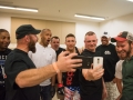 Austin Tweedy, center, and team watch the preceeding Extreme Combat Challenge fight via Facebook Live in the lockerroom before his bout in Muncie, Ind., on Saturday, Apr. 15, 2017. Photo by Lucas Carter.